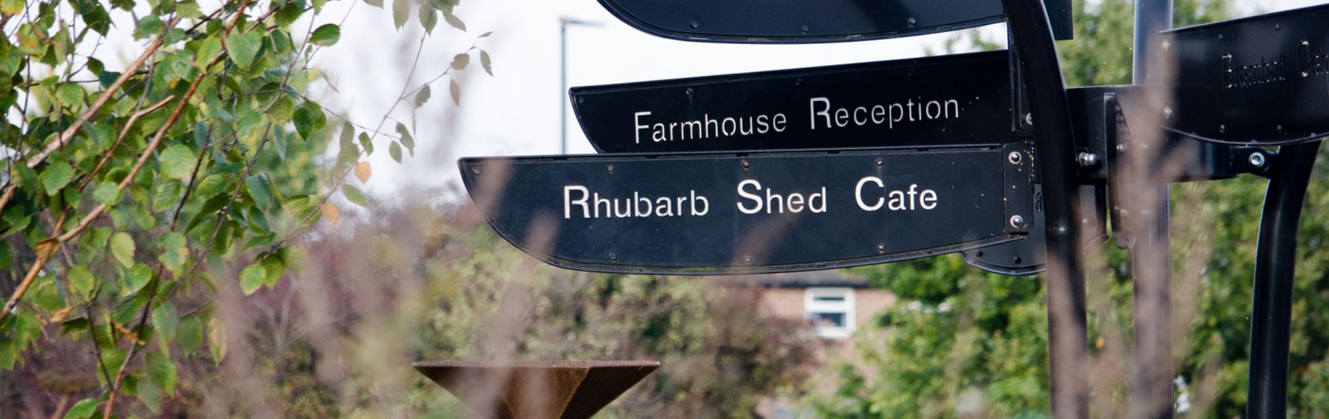A signpost at Manor Lodge Sheffield, one of which read Rhubarb Shed Cafe.