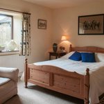 Loadbrook Cottage – double bedroom decorated in brown tones with bed and bedside tables.