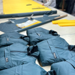 A table with Buffalo Systems clothing laid out.