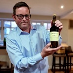 A man holding a bottle of whiskey.