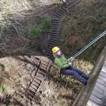 A person abseiling, out in the countryside. 