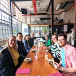 A group sat round a table on the Sheffield And Kelham Island Food Tour.