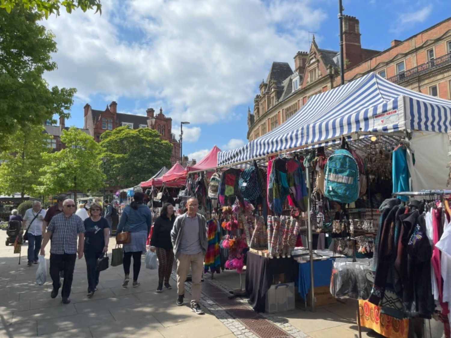 The Sheffield International Market from a previous year. Lots of people are looking around market stalls.