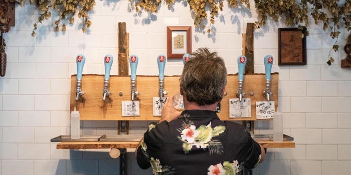 A man pulling a pint at The Brewery of St Mars of the Desert.