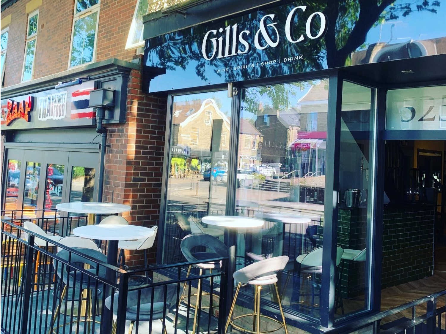 Table and chairs set out in the sun at Gills & Co.