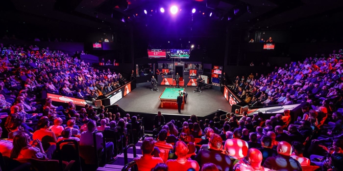 interior of the Crucible theatre showing audiences watching the World Snooker Championship 