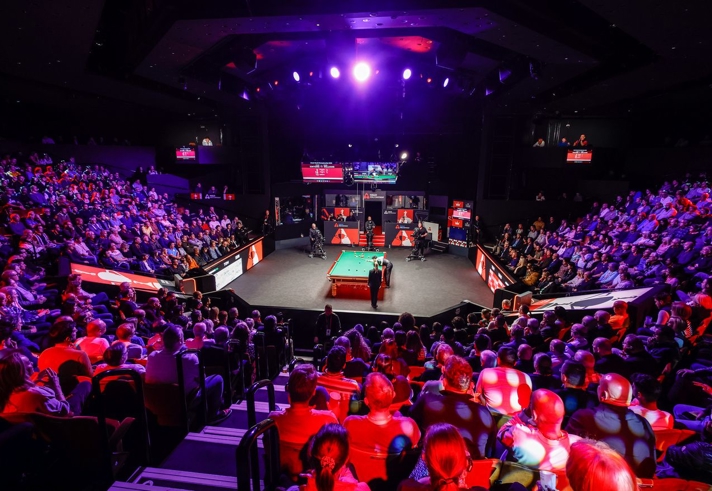 interior of the Crucible theatre showing audiences watching the World Snooker Championship 