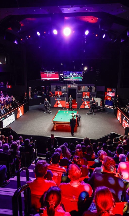 interior of the Crucible theatre showing audiences watching the World Snooker Championship 