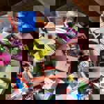 A pink round table with books arranged in a circle around the table.